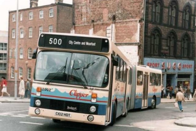 A Clipper bendibus on Castle Street, Sheffield city centre, with Sugg Sports shop in the background.