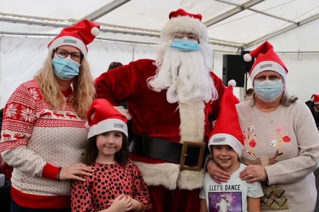 Santa Claus was everywhere at Mansfield's Winter Festival at Titchfield Park on Saturday, meeting and greeting families such as this one.