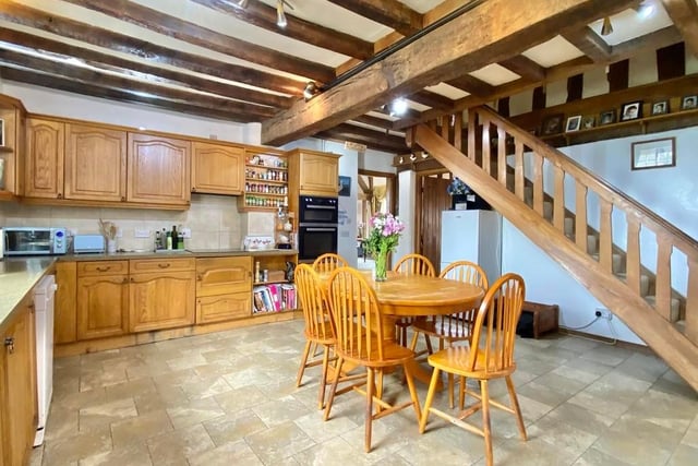The day begins with breakfast in this homely kitchen. It is fitted with a range of wall and base units, a stainless steel sink and integrated appliances, including a double oven, four-ring ceramic hob and built-in wine-cooler. A staircase rises to the east wing accommodation.