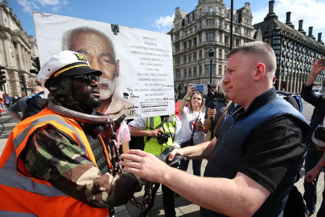 Britain First leader Paul Golding (right) shakes hands with a protester in Parliament Square. Picture: Jonathan Brady/PA Wire