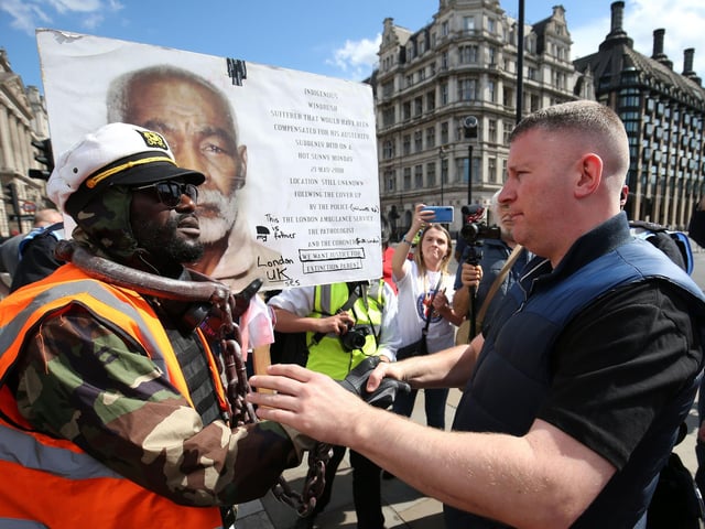 Britain First leader Paul Golding (right) shakes hands with a protester in Parliament Square. Picture: Jonathan Brady/PA Wire