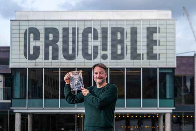 Tedd George with a copy of Stirring Up Sheffield outside the Crucible Theatre