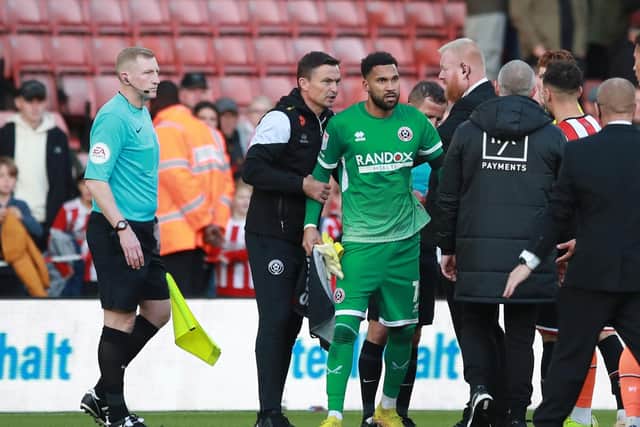 Paul Heckingbottom pulls Wes Foderingham away from the melee that followed Sheffield United's draw with Blackpool: Simon Bellis / Sportimage
