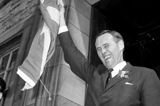 SNP politician William Wolfe raises the Scottish flag above his head in May 1966. He became the Honorary President (Rector) of the Students' Association at Heriot-Watt University early May.