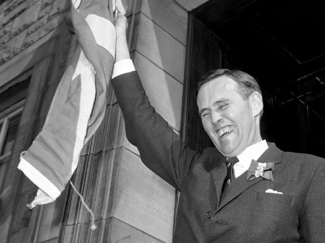 SNP politician William Wolfe raises the Scottish flag above his head in May 1966. He became the Honorary President (Rector) of the Students' Association at Heriot-Watt University early May.