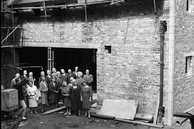 A group inspect the state of Dalry House in July 1966.