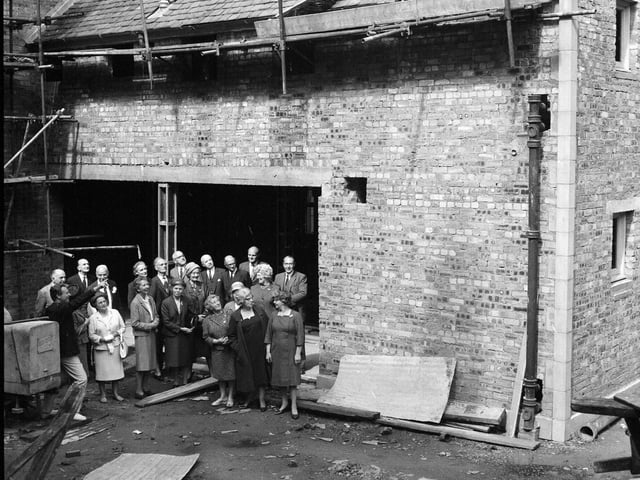 A group inspect the state of Dalry House in July 1966.