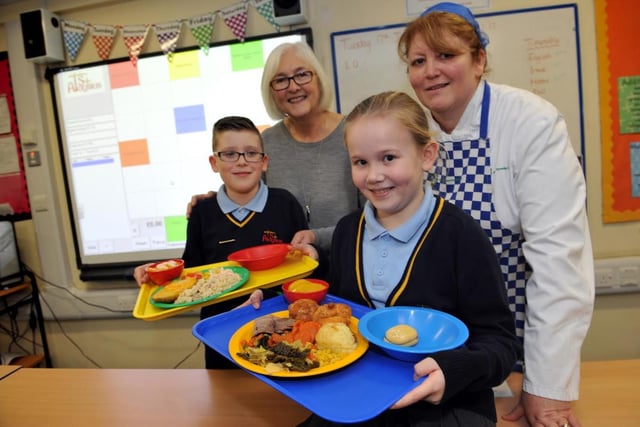 Coun Joan Atkinson joins St Aloysius Primary Federation pupils Ethan Holmes and Jessica Kane for lunch in 2017, with cook in charge Judith Todd.