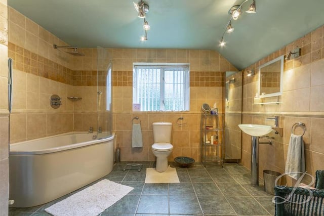 This en suite to the main bedroom is big and bright. It comprises a bath, low-flush WC, wash hand basin, cupboard for storage and an opaque window to the back.