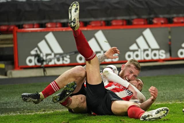Billy Sharp celebrates with Oli McBurnie after scoring the winner in Sheffield United's 2-1 win over West Bromwich Albion at Bramall Lane.  (Photo by DAVE THOMPSON/POOL/AFP via Getty Images)