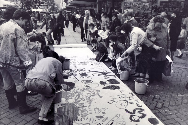 Children take part in painting the longest mural on the Moor during this week's Children's Festival as part of the Moor the Merrier Week in October 1987