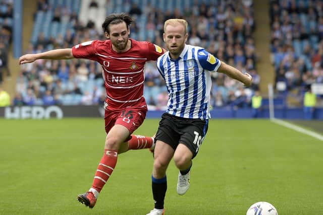 Sheffield Wednesday's Barry Bannan tussles with Aidan Barlow of Doncaster Rovers in the reverse fixture. Photo: Steve Ellis.
