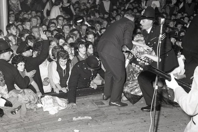 The Beatles in Buxton - John Lennon plays on as fainting fans are carried from the audience at Buxton's Pavilion Gardens in 1963
