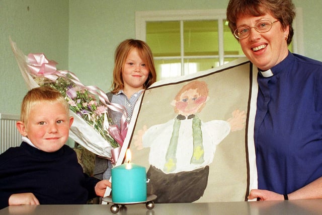 The Rev Joan Ashton who is vicar at Saint Mary's Stainforth was presented with gifts and this Painting by Aaron Crichton (7) to mark her leaving Stainforth in 1998 to become priest in charge at all saints at Arksey. Rev Ashton pictured here with 7 year old Katie Lee was a regular visitor at Stainforth Infants School where the presentation took place and will also take up a part time post as the chaplin of Doncaster royal infirmary. During a special assembly a candle was lit , by Rev Ashton and dedicated to the children.