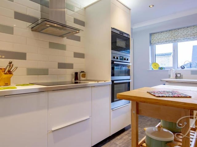 The stylish kitchen is the first room that catches the eye. It comes complete with a range of modern units, cabinets and integrated appliances.