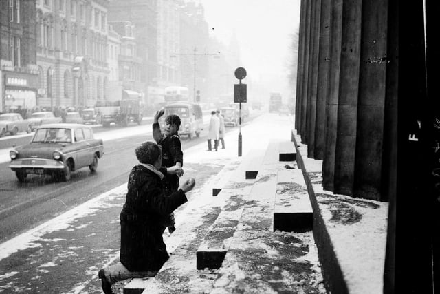 Two boys have a snow fight outside RSA in Princes Street, Edinburgh. 28 December, 1962