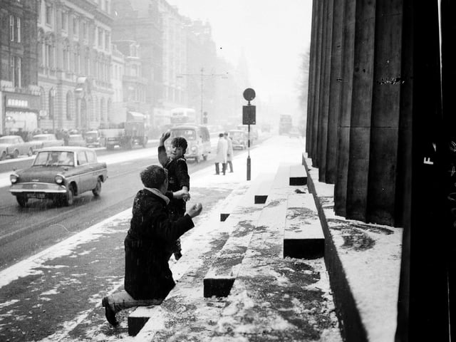 Two boys have a snow fight outside RSA in Princes Street, Edinburgh. 28 December, 1962
