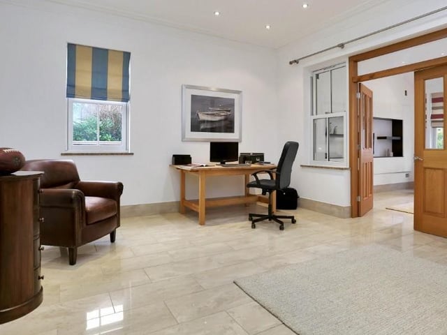 From both the dining kitchen and the sun room, you can move into this family room. It can be used as an additional living room, a children's play room or an office to work from home.