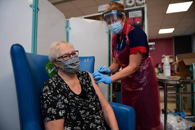 A nurse prepares to administer the Pfizer-BioNTech COVID-19 vaccine to patient Trixie Walker at the Northern General Hospital (Photo by Andy Stenning - Pool/Getty Images).