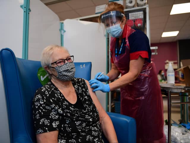 A nurse prepares to administer the Pfizer-BioNTech COVID-19 vaccine to patient Trixie Walker at the Northern General Hospital (Photo by Andy Stenning - Pool/Getty Images).