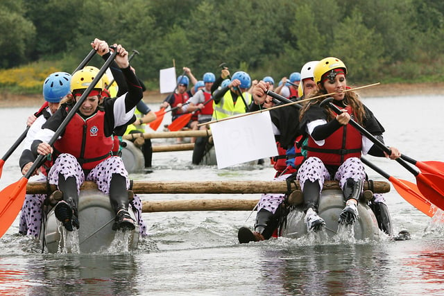 Severn Trent Water's 'Chesty Treasures' drive for the shore as they take the lead in the Water Aid raft race at Carsington Water in 2006