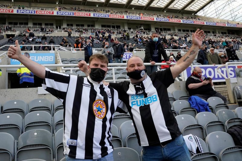 Two Newcastle fans pose for a photo together on their return to St James's Park.