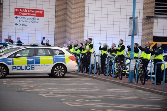 Police officers can be seen lining up, showing their support for NHS workers.