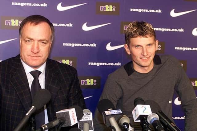 Rangers manager Dick Advocaat unveils his new £12million striker Tore Andre Flo.