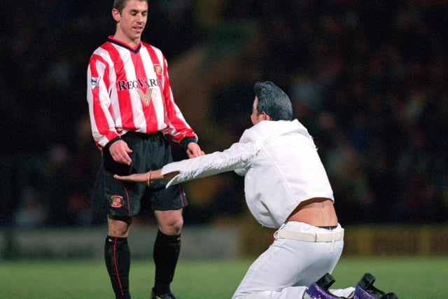 An Elvis Impersonator worships at the feet of Kevin Phillips of Sunderland during the FA Carling Premiership game against Bradford City at Valley Parade in Bradford, England. Sunderland won the match 4-1.