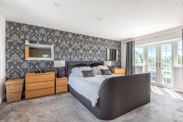 The property has four bedrooms in total. This modern bedroom boasts its own spacious balcony