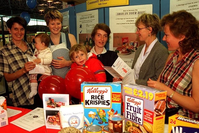 The Community Health held an iron deficiency awareness day in the Sheaf Market in 1996. Seen, left to right, are: Wendy Eggleton with Lauren, Michaela Swindells, Joanne Savage with Dale, dietitian Val Naylor, and Chris Gash,  health visitor