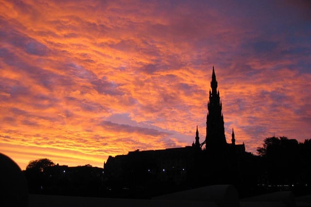 A silhouette of the Scott Monument with a clouded orange sky behind.