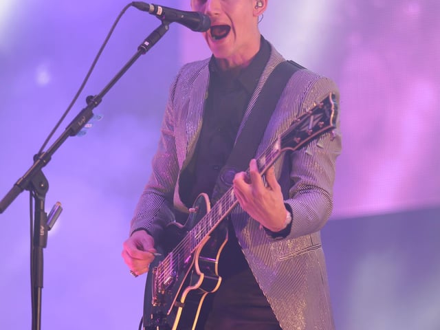 Alex Turner of the Arctic Monkeys performing on the Pyramid Stage at Glastonbury 2013