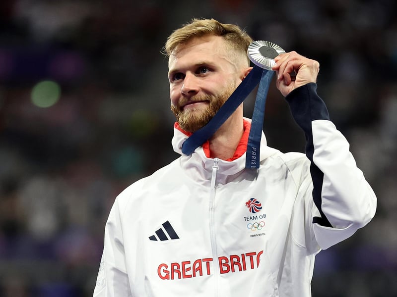 Scottish hero and silver medallist Josh Kerr of Great Britain celebrates on the podium during the men's 1500m medal ceremony on day eleven of the Olympic Games Paris 2024.