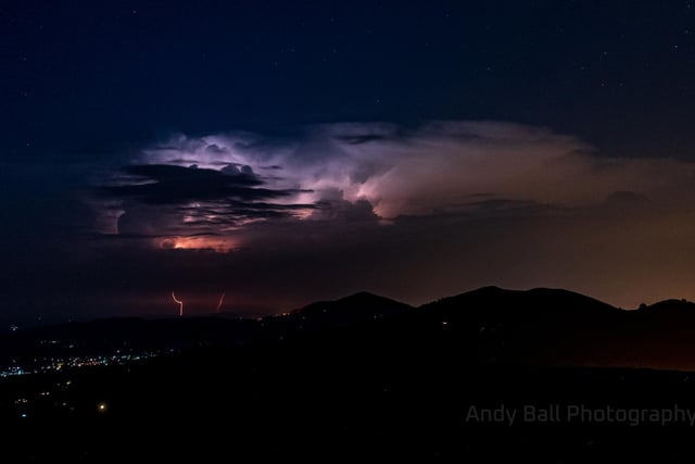 The skies above the Malvern Hills, located in the South of England, lit up in bright purple, blue and pinks as thunderstorms hit (Photo: Andy Ball)