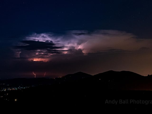 The skies above the Malvern Hills, located in the South of England, lit up in bright purple, blue and pinks as thunderstorms hit (Photo: Andy Ball)