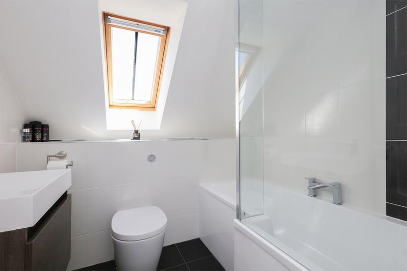 The second-floor bathroom is among five in the property.