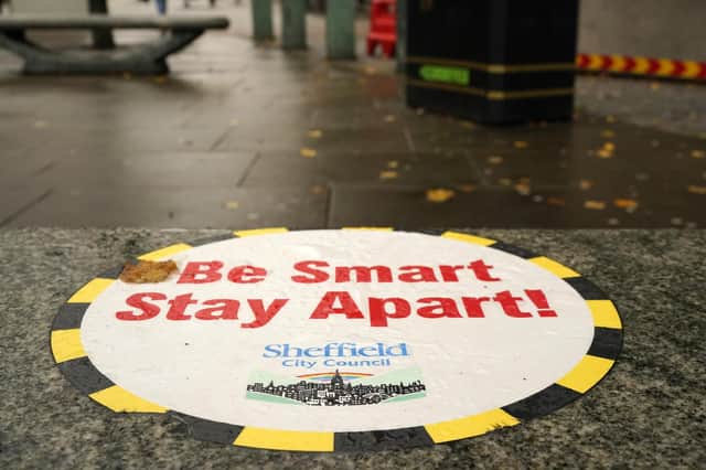 A Covid-19 awareness sign greets shoppers in the city centre on October 22, 2020 in Sheffield, England. The county of South Yorkshire, which includes the city of Sheffield has moved to Tier 3 'Very High' Covid-19 alert