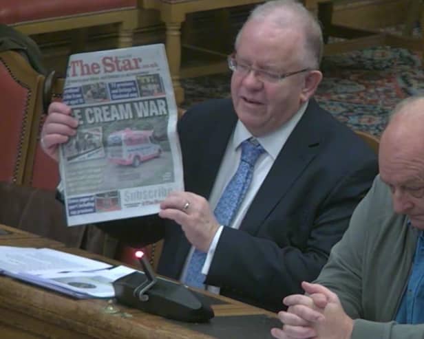Neale Gibson, representing Andrew Cuneo, right, holding up a copy of The Star at a meeting of Sheffield City Council's planning committee