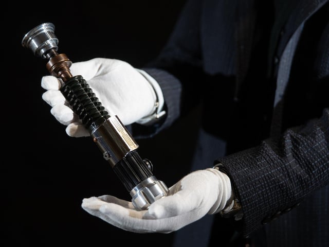 Obi-Wan Kenobi's (Ewan McGregor) lightsaber from the 2005 film 'Star Wars: Revenge of the Sith' (estimate £80,000-£120,000).
