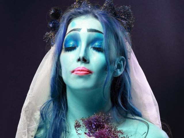Create the zombie bride look with pale white or blue face paint (or foundation and eye shadow), and add dustings of black around the eyes for that deathly feel, complete with frosty blue or pink lipstick.
