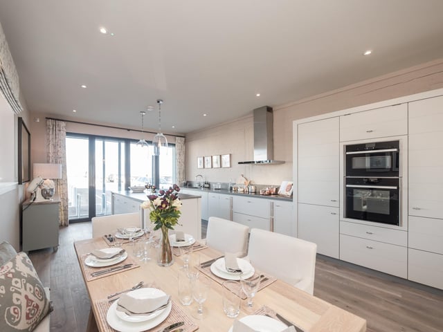 The large dining area in a penthouse at the Moorings waterside development offers unparalleled views. Contact DJ Alexander for more information or to arrange a show home tour.
