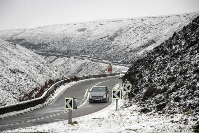 A car navigates the Snake Pass in Derbyshire, as a blast of snow hits the north of England. Photo: Danny Lawson/PA Wire