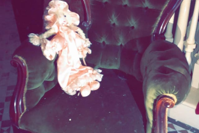 What's a creepy mansion without an abandoned doll? This one lies abandoned on a plush velvet chair. Who did it belong to?