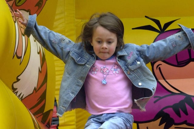 Lucy Lancaster, five, from Brinsworth on the Flintstone slide at  Mayfest in 2001