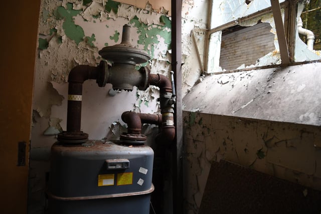 An old gas meter tucked away in a dark corner