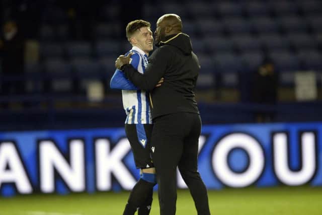 Sheffield Wednesday manager Darren Moore embraces Josh Windass after his last-gasp winner earned the Owls three points from MK Dons.