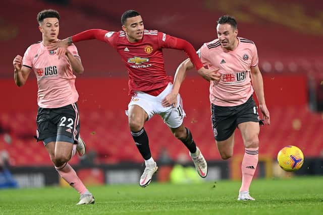 Sheffield United's Phil Jagielka tussles with Manchester United's young striker Mason Greenwood during the Blades' 2-1 win at Old Trafford last night. (Photo by Laurence Griffiths/Getty Images)