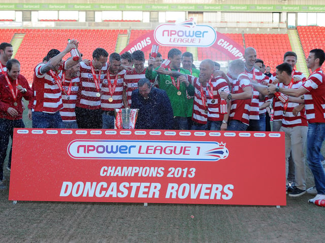 Champagne is sprayed as the Rovers squad receive the League One trophy