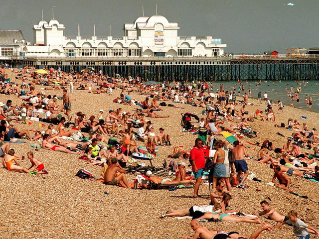 The News reader, Ann Palmer, suggested to go and paddle in the sea once you get here. This was a packed Southsea beach in 1999.